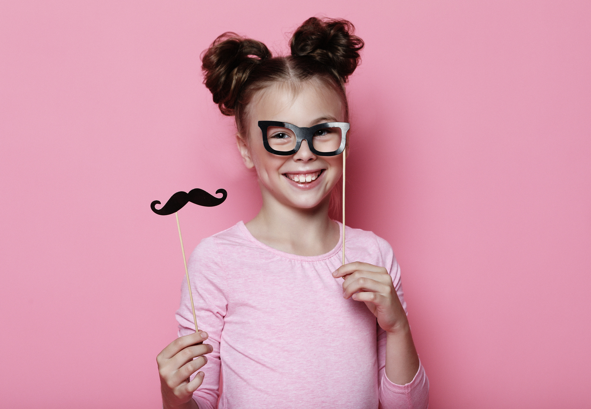 Girl pose with photo booth props glasses and mustache